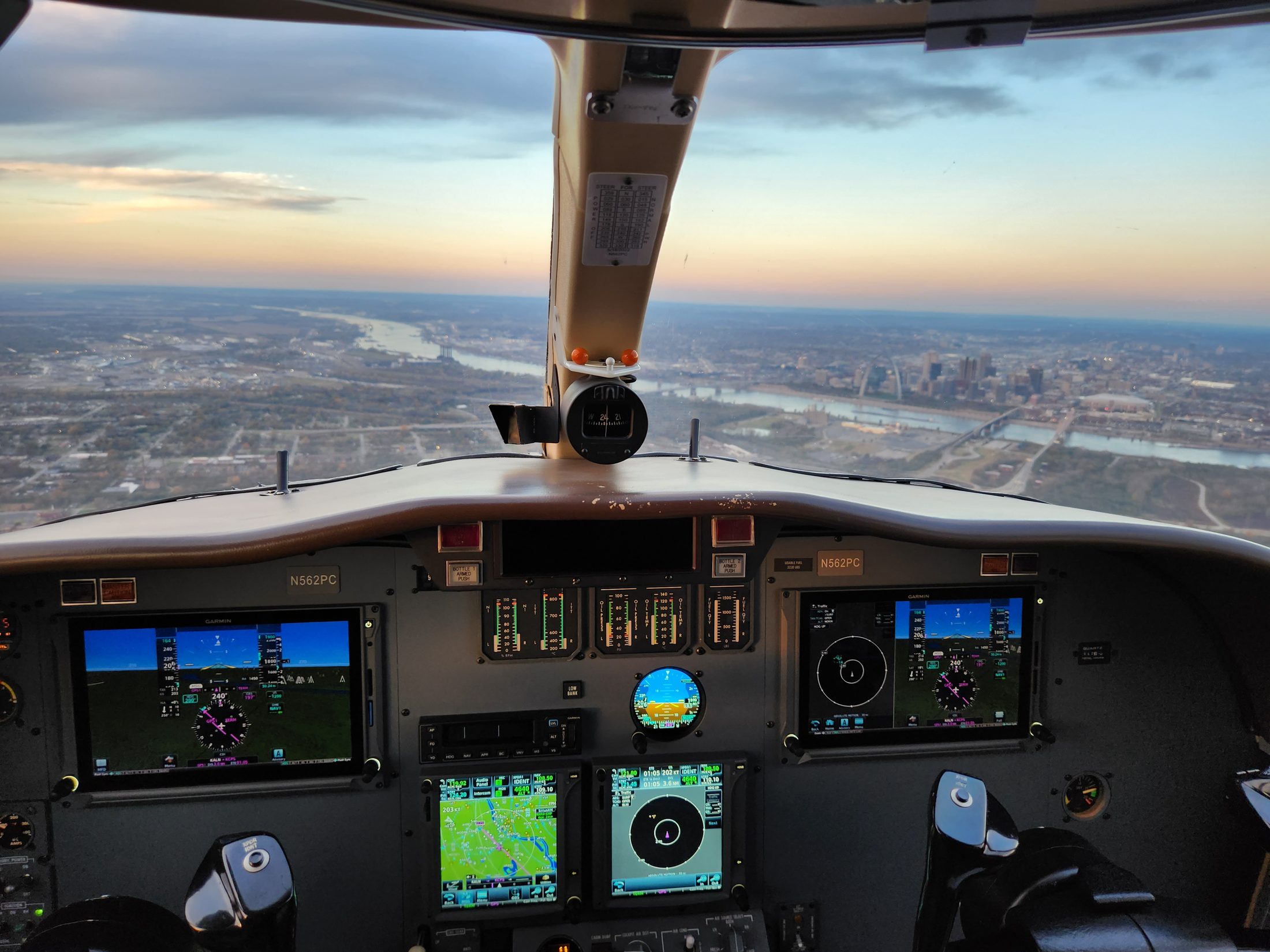 View from a Citation cockpit on approach over downtown St. Louis, with the Gateway Arch and Mississippi River ahead